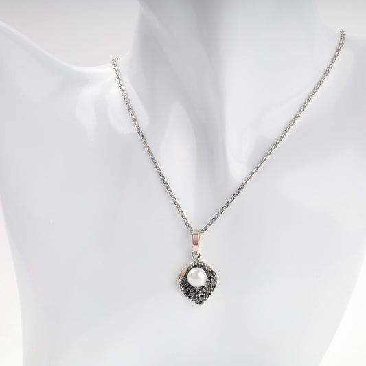 Pearl and dark cubic zirconia pendant shown on chain — Kabluchka