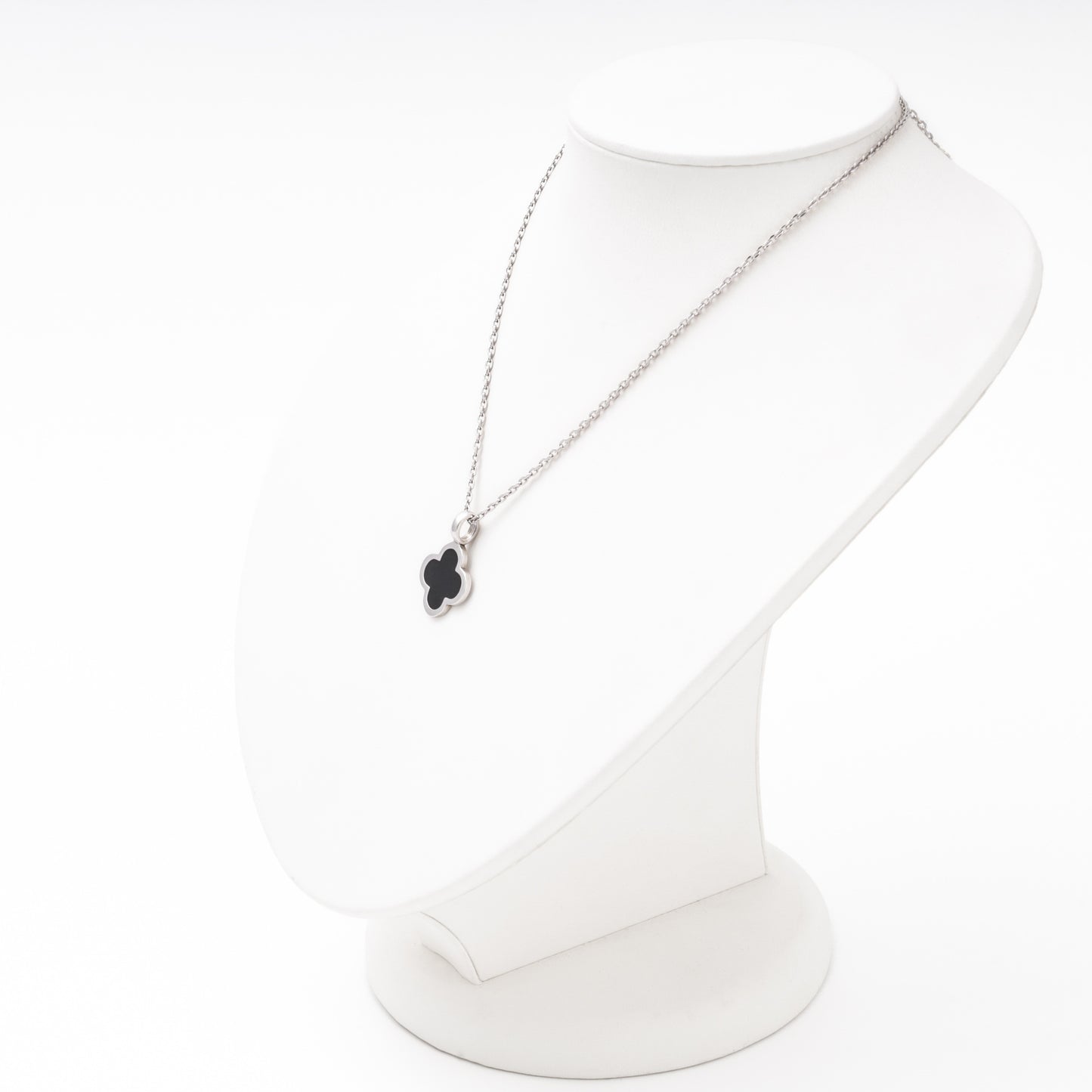 Silver clover pendant with black enamel worn on necklace angled — Kabluchka