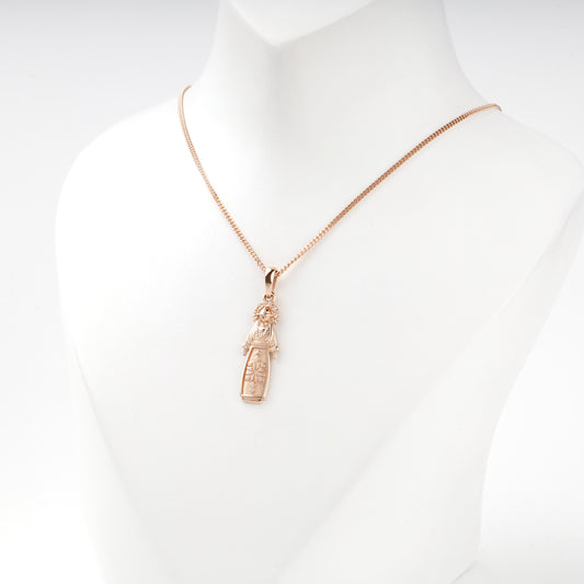 Rose Gold 14K motanka pendant with raised ornament, angled view