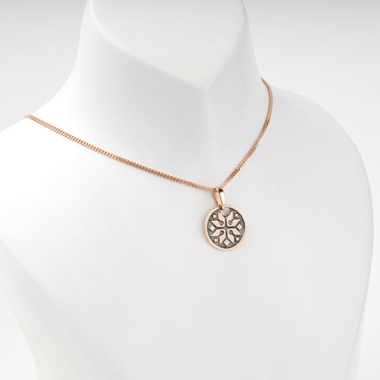 Rose Gold 14K eight-rayed ornamental pendant, angled view