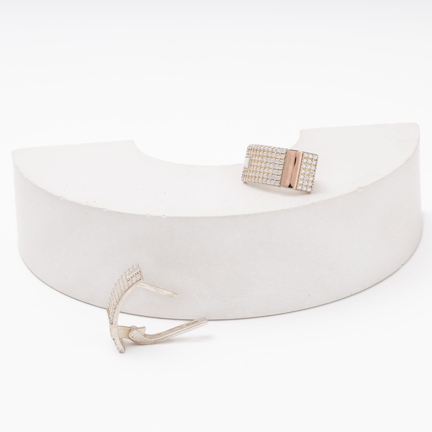 Silver 925 earring with CZ pavé and gold accent next to matching ring — Kabluchka