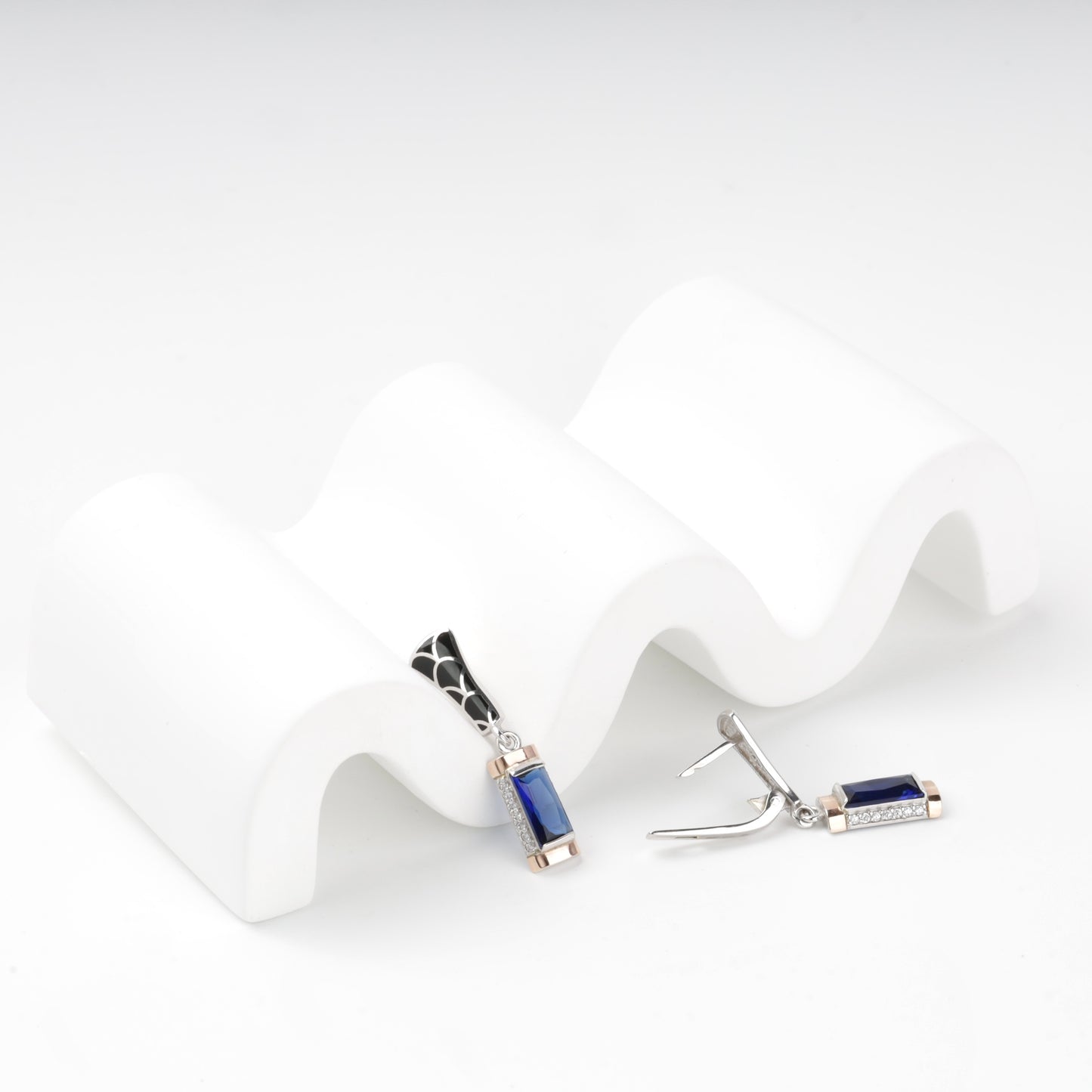 Side view of blue alpinite earrings with gold accents