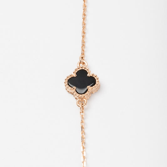 An exquisite 14K (585) Rose Gold bracelet featuring a black four-leaf clover centerpiece accented on a delicate chain with an adjustable clasp.