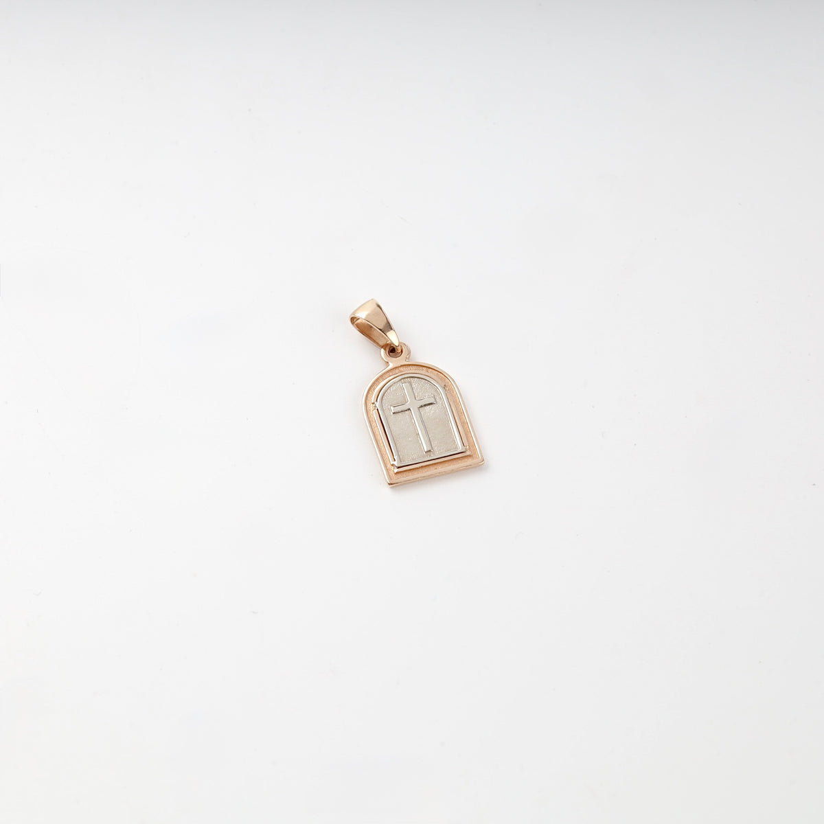 Two-tone gold religious pendant with cross motif on reverse
