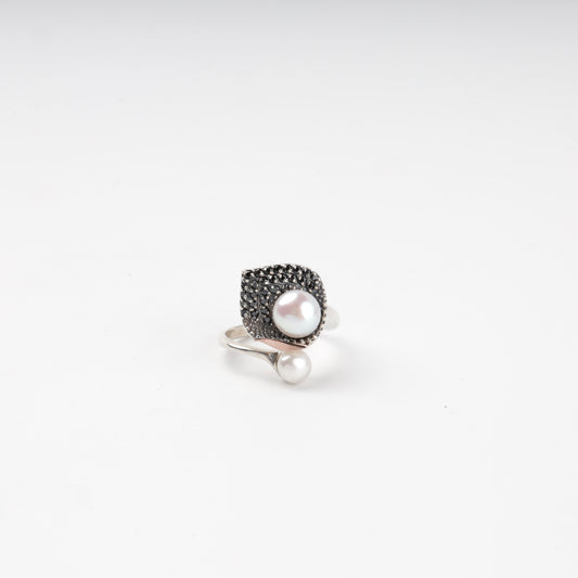 Asymmetrical pearl and dark cubic zirconia ring — front view — Kabluchka