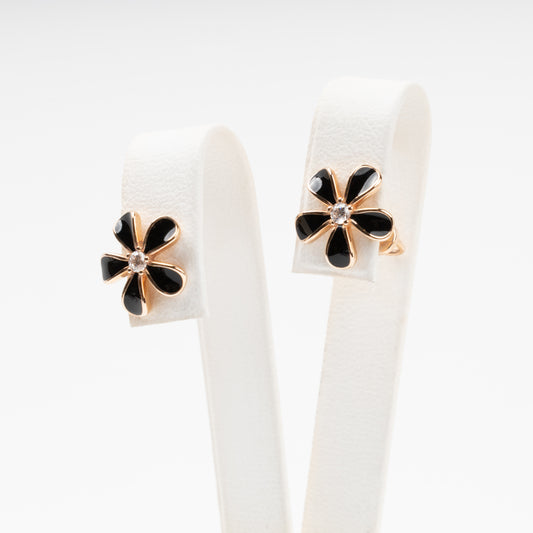 14K (585) Rose Gold flower stud earrings with black enamel petals and a central cubic zirconia, displayed on a white jewelry stand.
