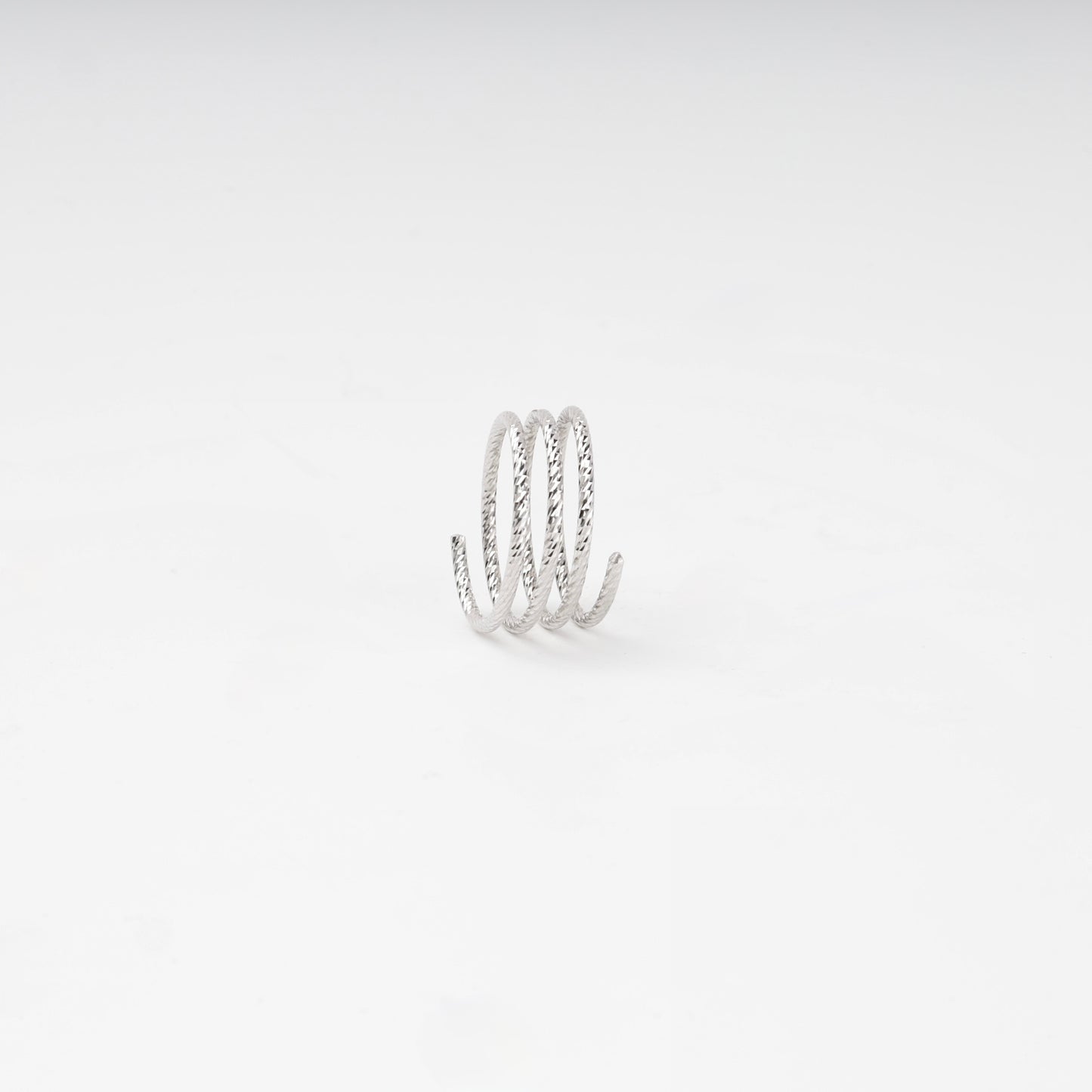 Layered open ring with diamond-cut texture — close-up — Kabluchka