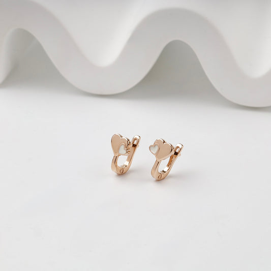 Rose Gold double heart kids earrings with white enamel, angled pair