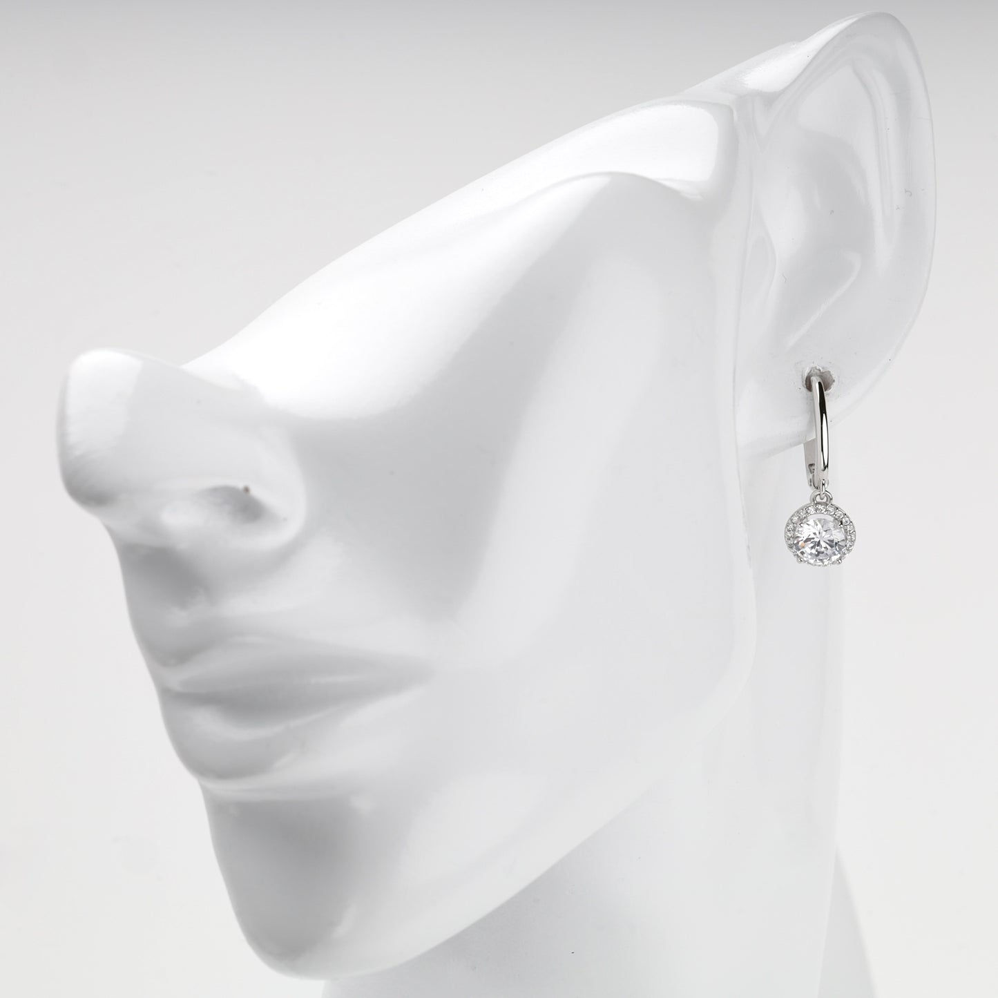 White Gold halo drop earring shown on ear