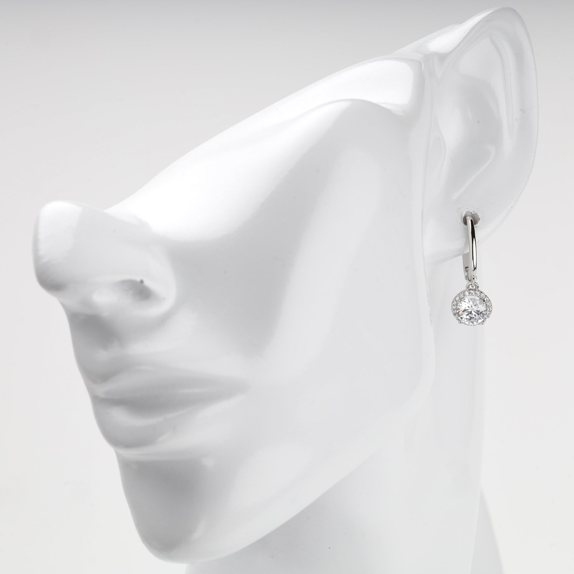 White Gold halo drop earring shown on ear
