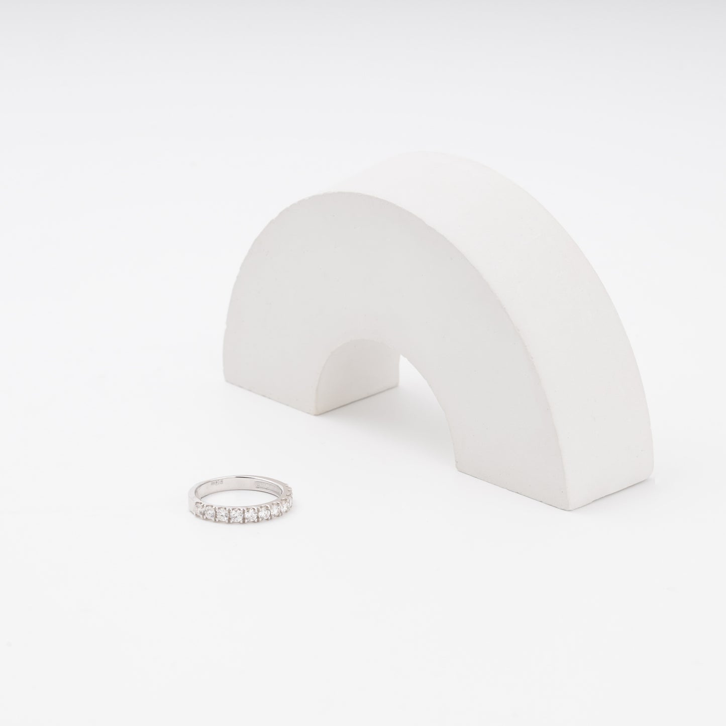 White gold diamond engagement ring beside display prop - Kabluchka jewelry