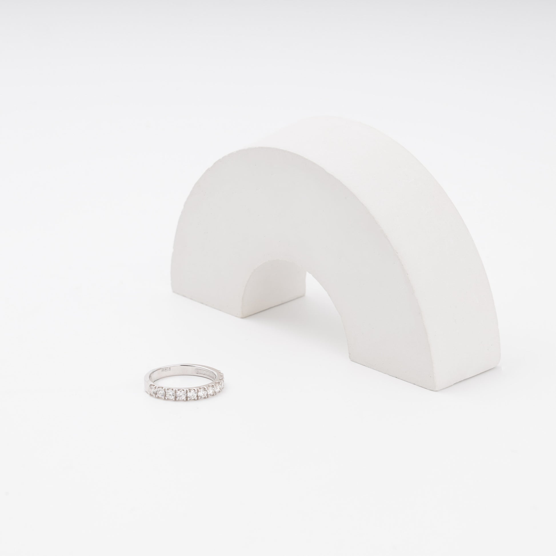 White gold diamond engagement ring beside display prop - Kabluchka jewelry