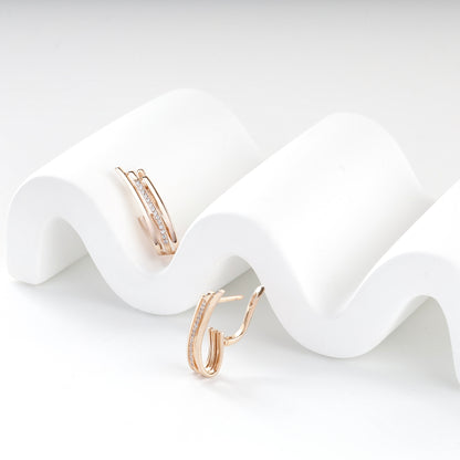 Polished rose gold geometric earrings with cubic zirconia accents