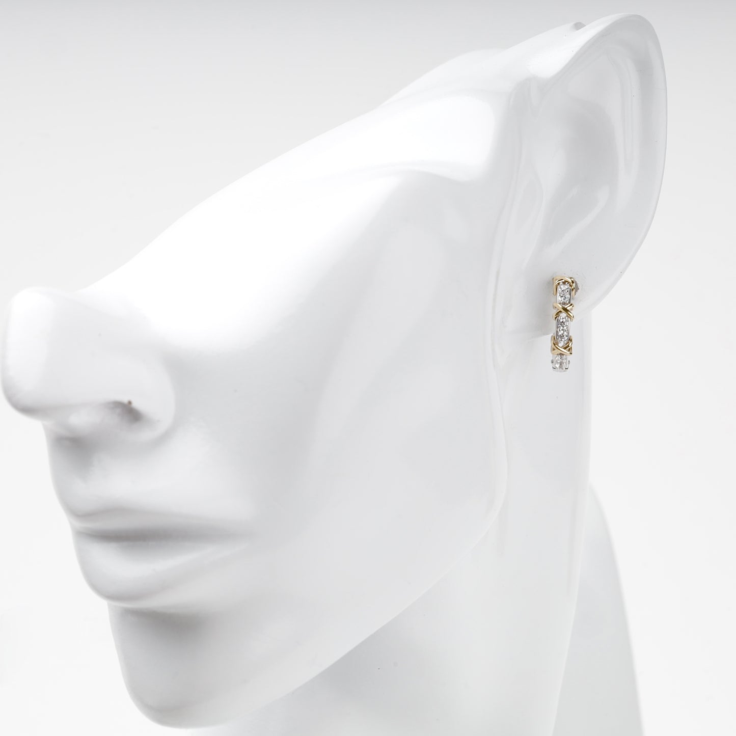 White and yellow gold cubic zirconia huggie on ear