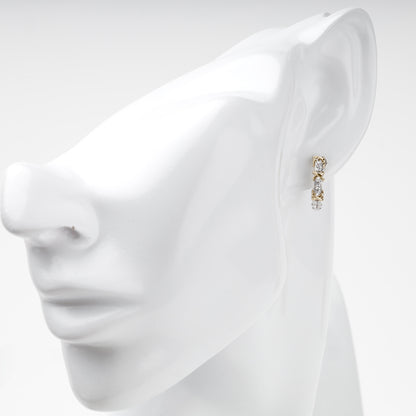White and yellow gold cubic zirconia huggie on ear