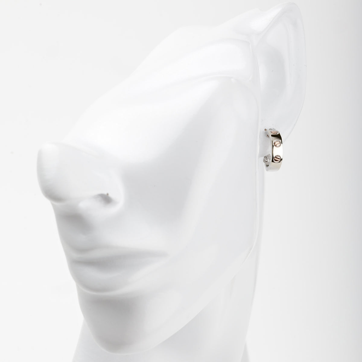 White and rose gold 585 screw motif hoop earrings, angled view