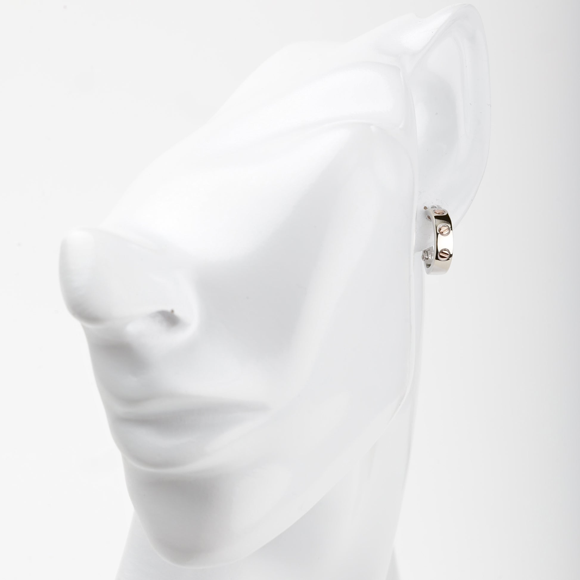 White and rose gold 585 screw motif hoop earrings, angled view