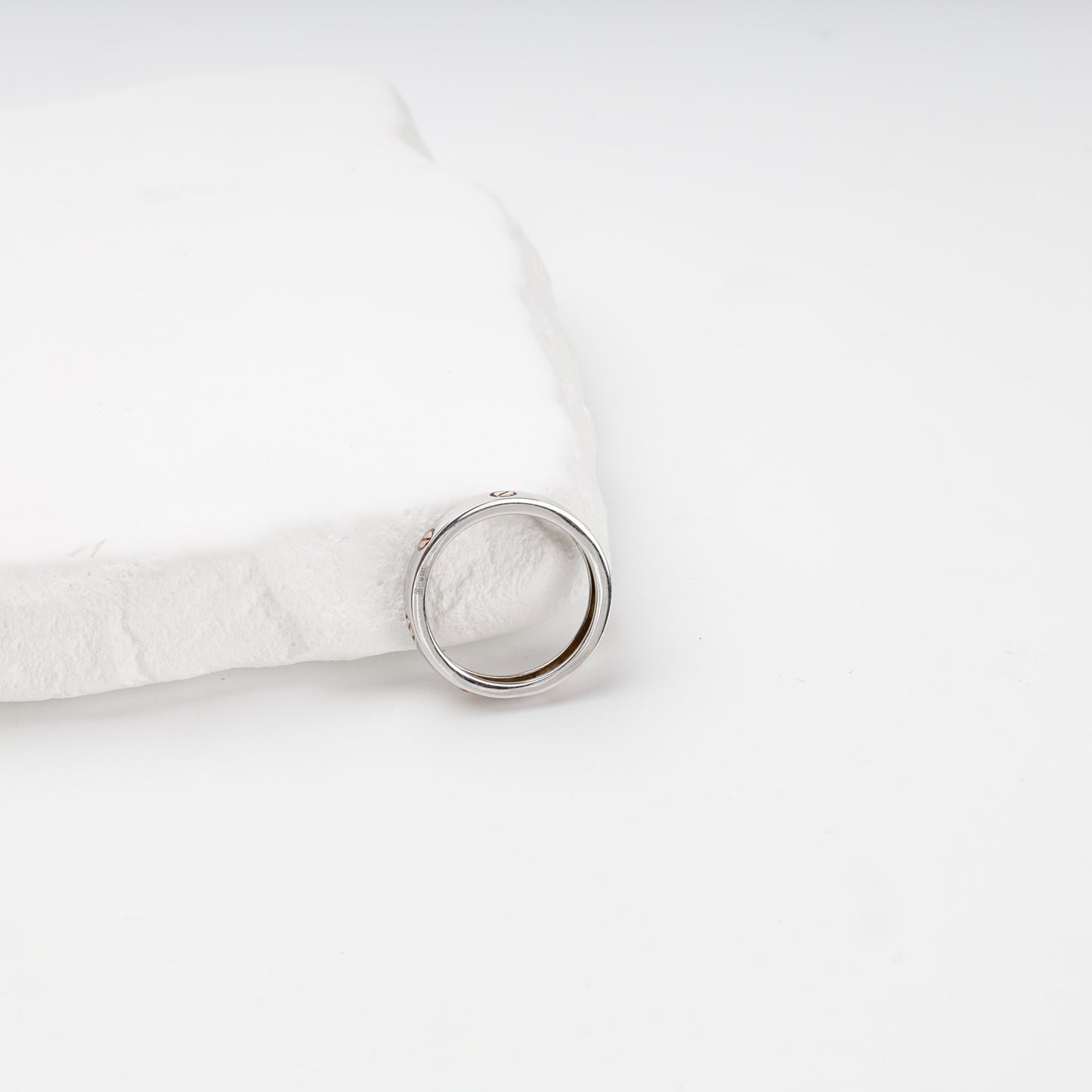 Polished two-tone gold band ring showing inner profile