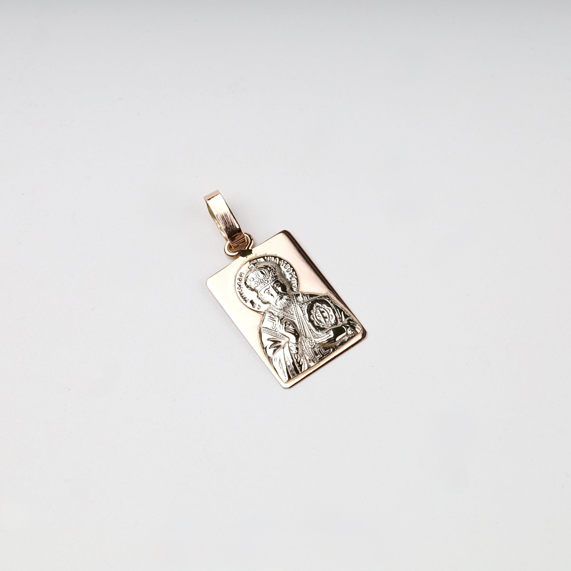 White relief detail on a Gold 14K Saint Nicholas pendant