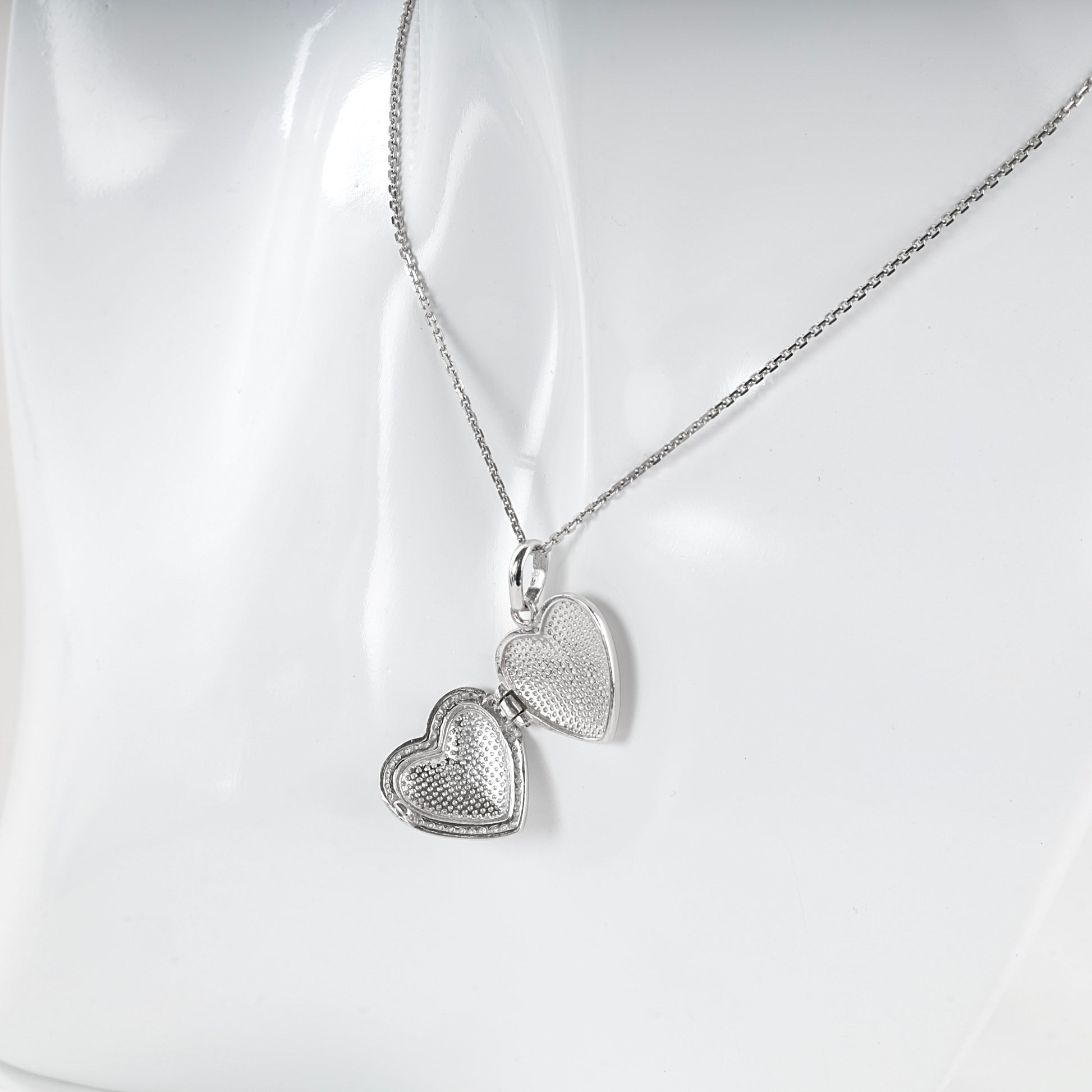 Silver heart locket pendant shown with a styling chain