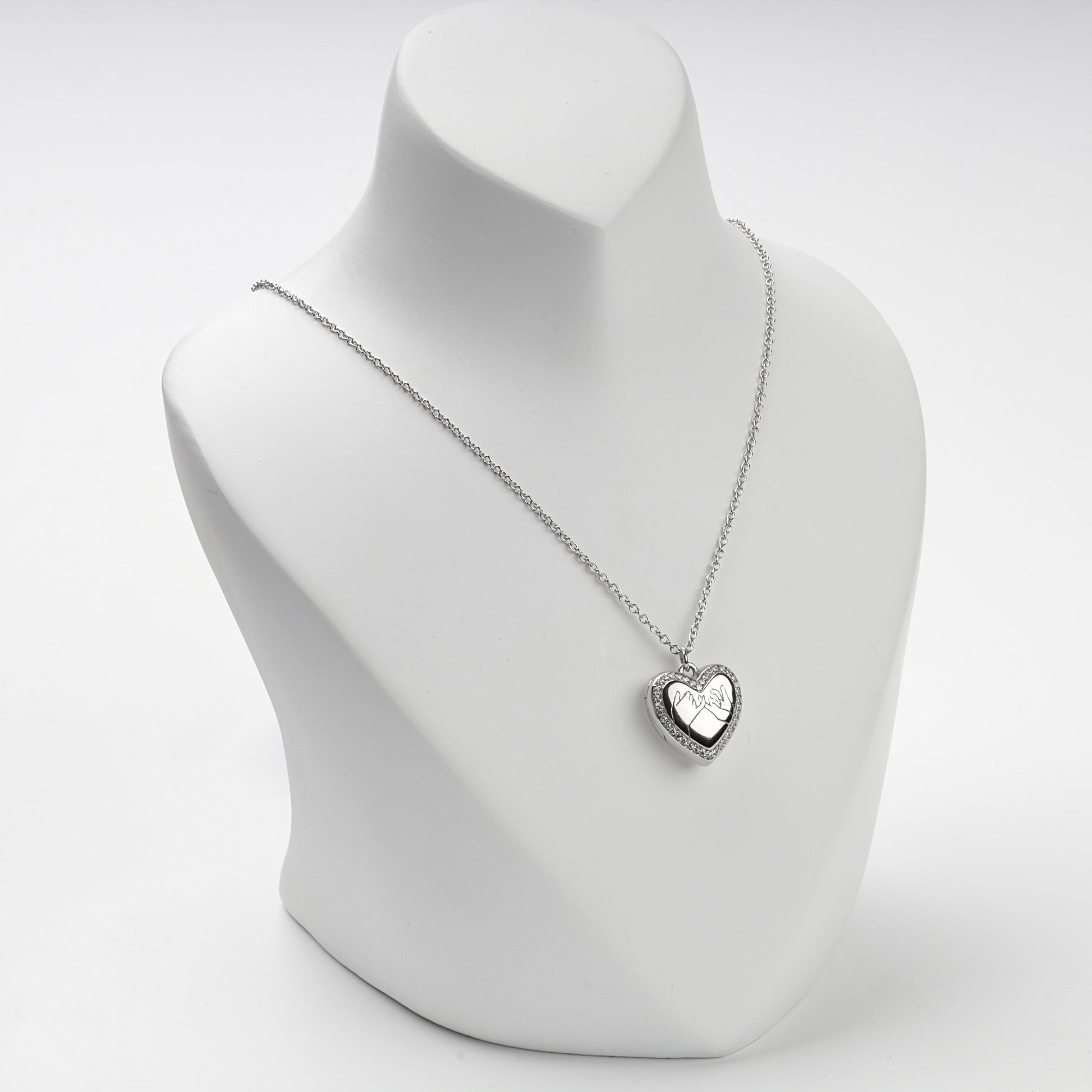 Silver 925 heart locket necklace on display