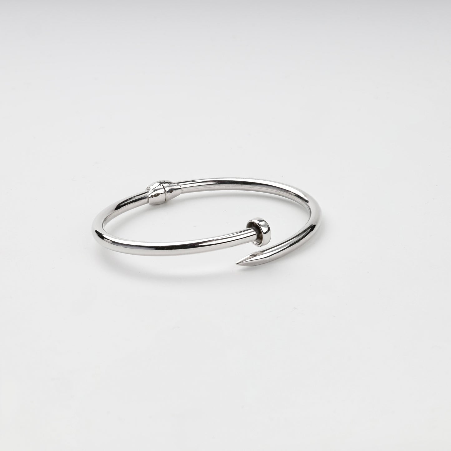 Open nail bangle bracelet showing pointed tip and flat head