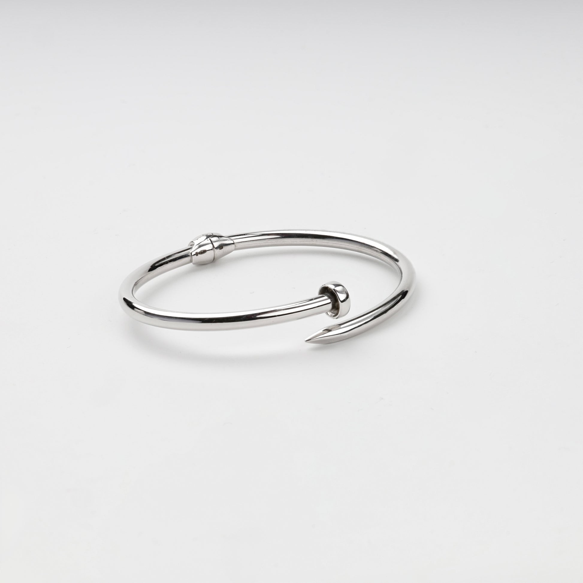 Open nail bangle bracelet showing pointed tip and flat head