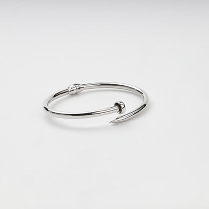 Open nail bangle bracelet showing pointed tip and flat head