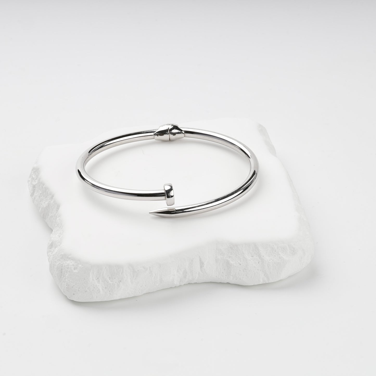 Rhodium-plated Silver 925 nail bangle on stone display