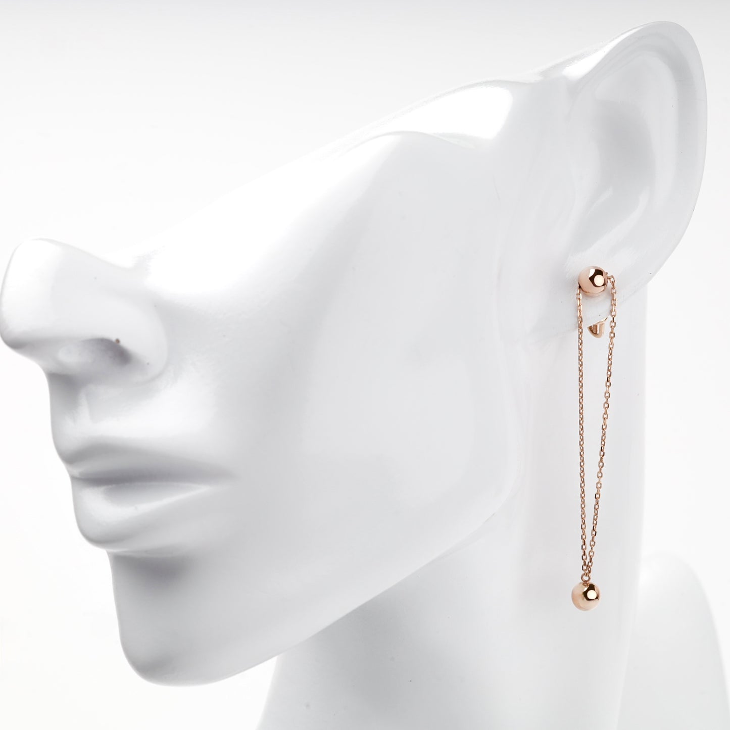 Rose gold double-chain ball drop earring on ear — Kabluchka