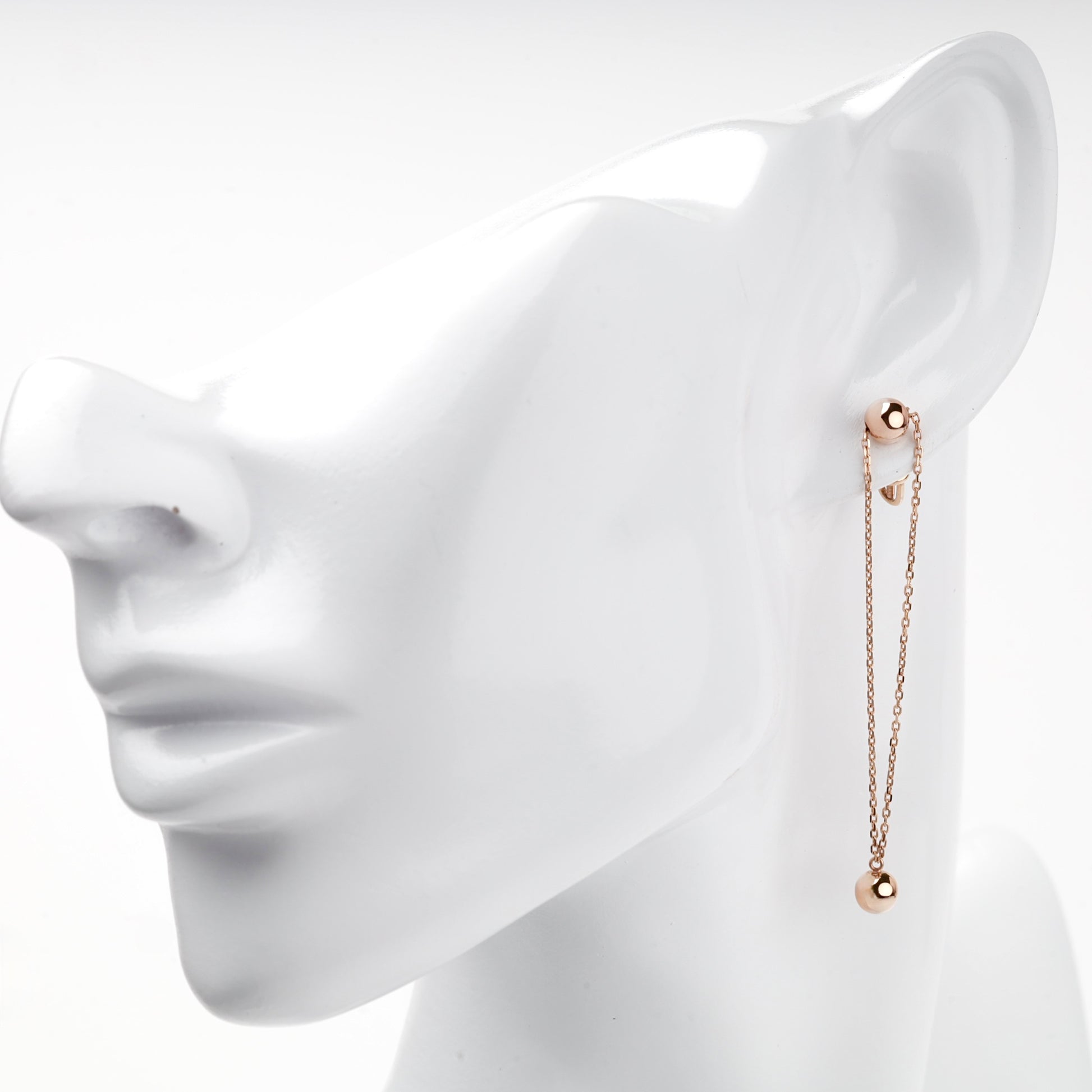 Rose gold double-chain ball drop earring on ear — Kabluchka