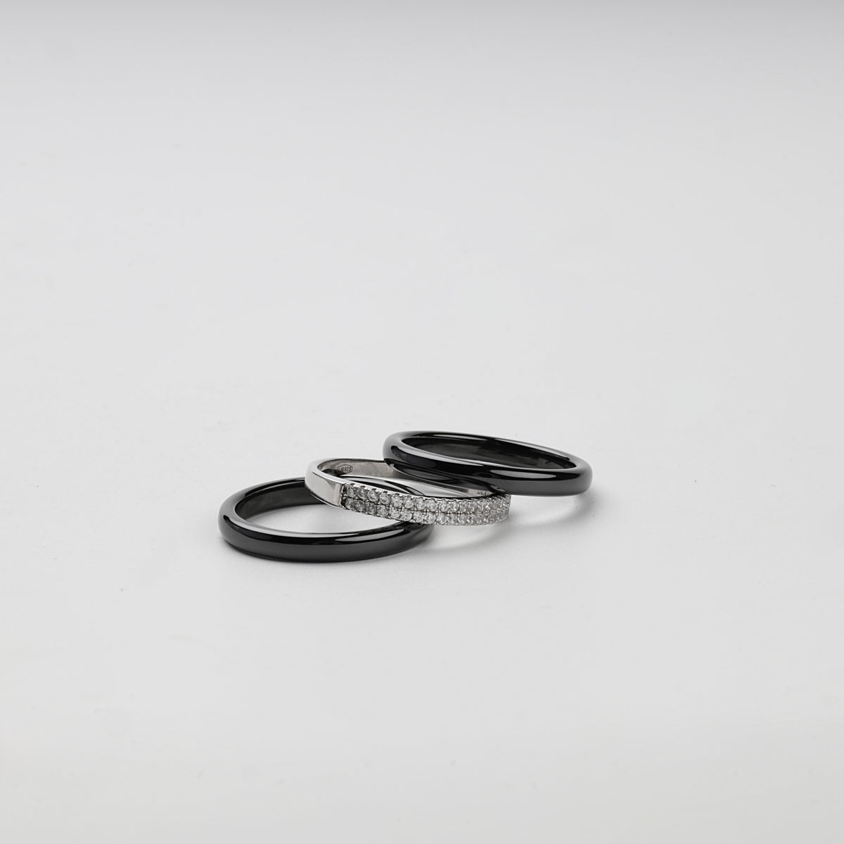 Separate black ceramic and Silver 925 cubic zirconia rings arranged together