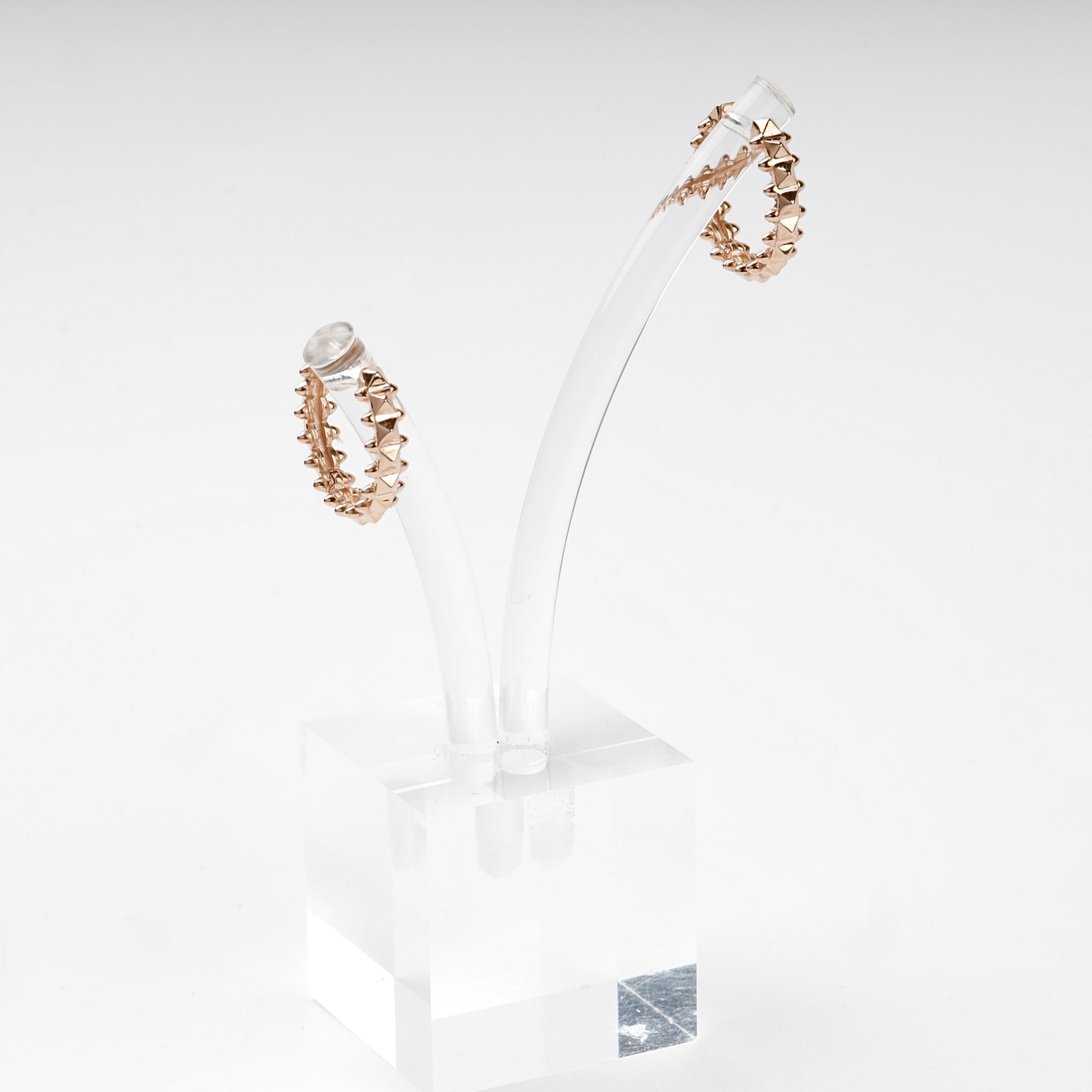 Rose Gold geometric hoop earrings on display stand