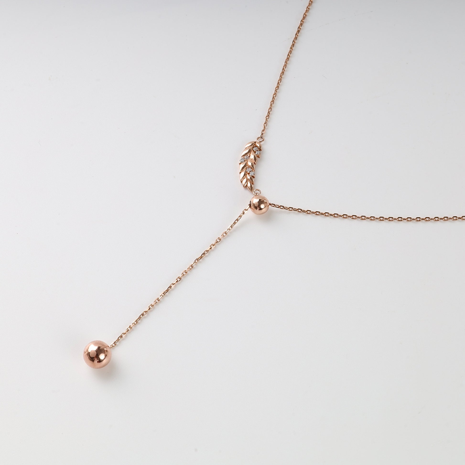 Aurelia Y-necklace rose gold with leaf pendant on white — Kabluchka Ukrainian gold