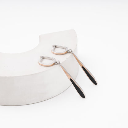 Black enamel teardrop earrings on model — silver and rose gold — Kabluchka