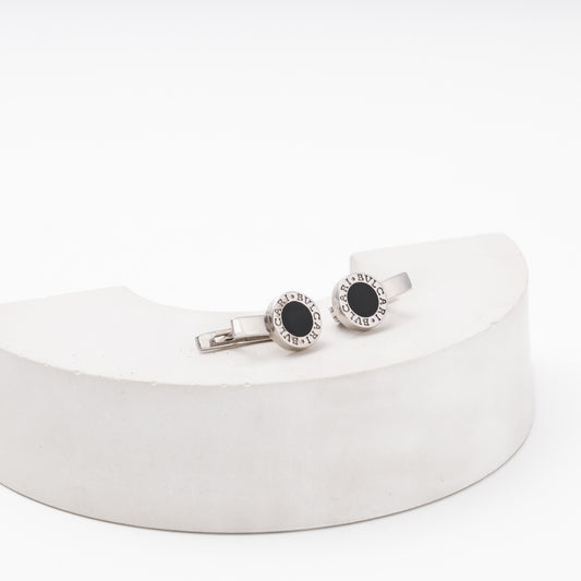 Silver earrings with round black enamel top on display block — Kabluchka