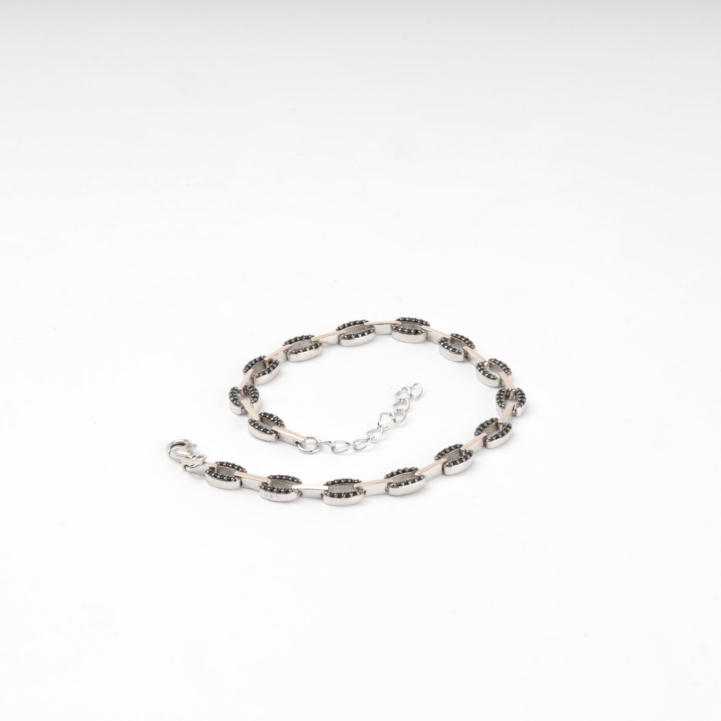 Black cubic zirconia link bracelet laid flat — Kabluchka