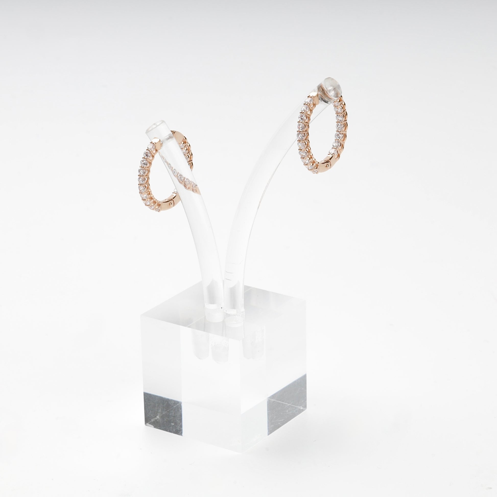 Inside-out rose gold hoop earrings on display stand