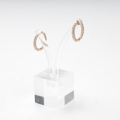 Inside-out rose gold hoop earrings on display stand