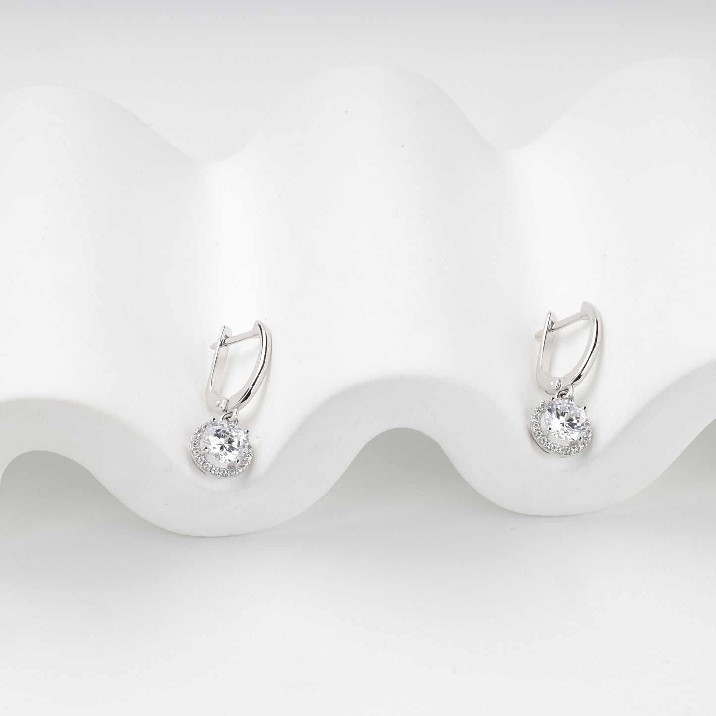 Cubic zirconia halo drops with English-lock closures