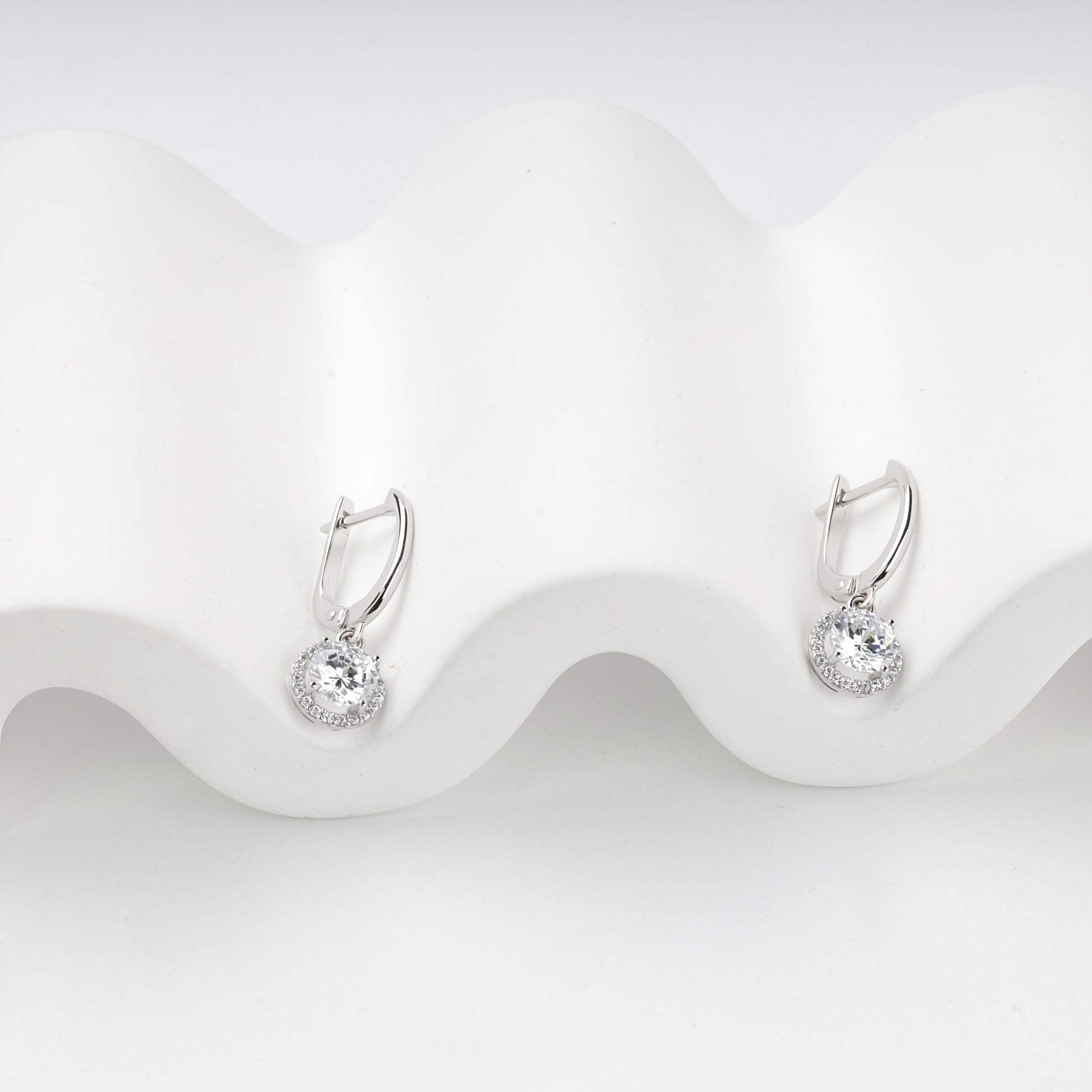 Cubic zirconia halo drops with English-lock closures