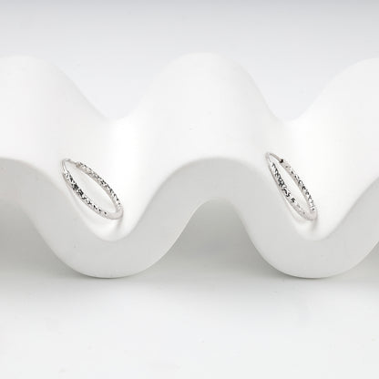 Silver 925 textured hoop earrings, angled view