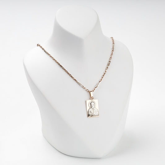 Saint Nicholas gold icon pendant shown with a styling chain