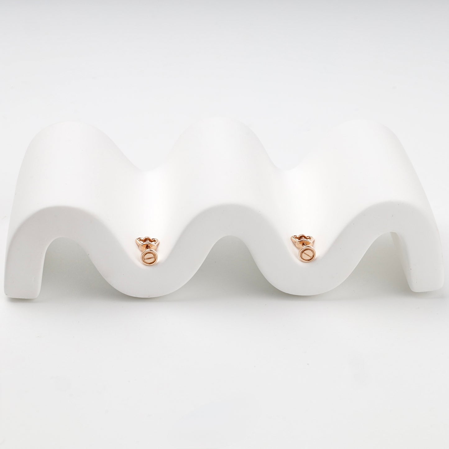 Minimalist round screw motif stud earrings on display — Kabluchka