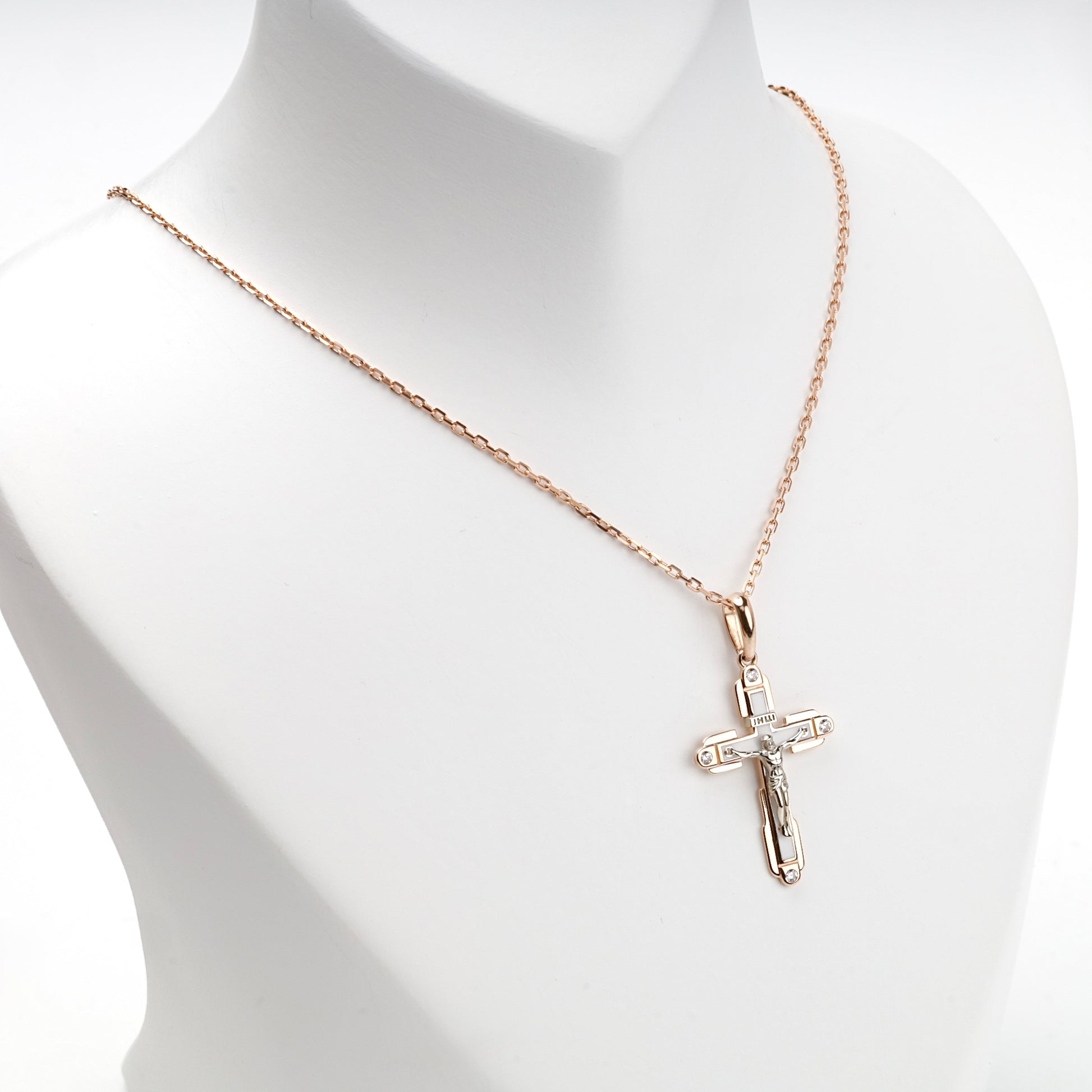 Two-tone religious cross pendant, angled view — Kabluchka