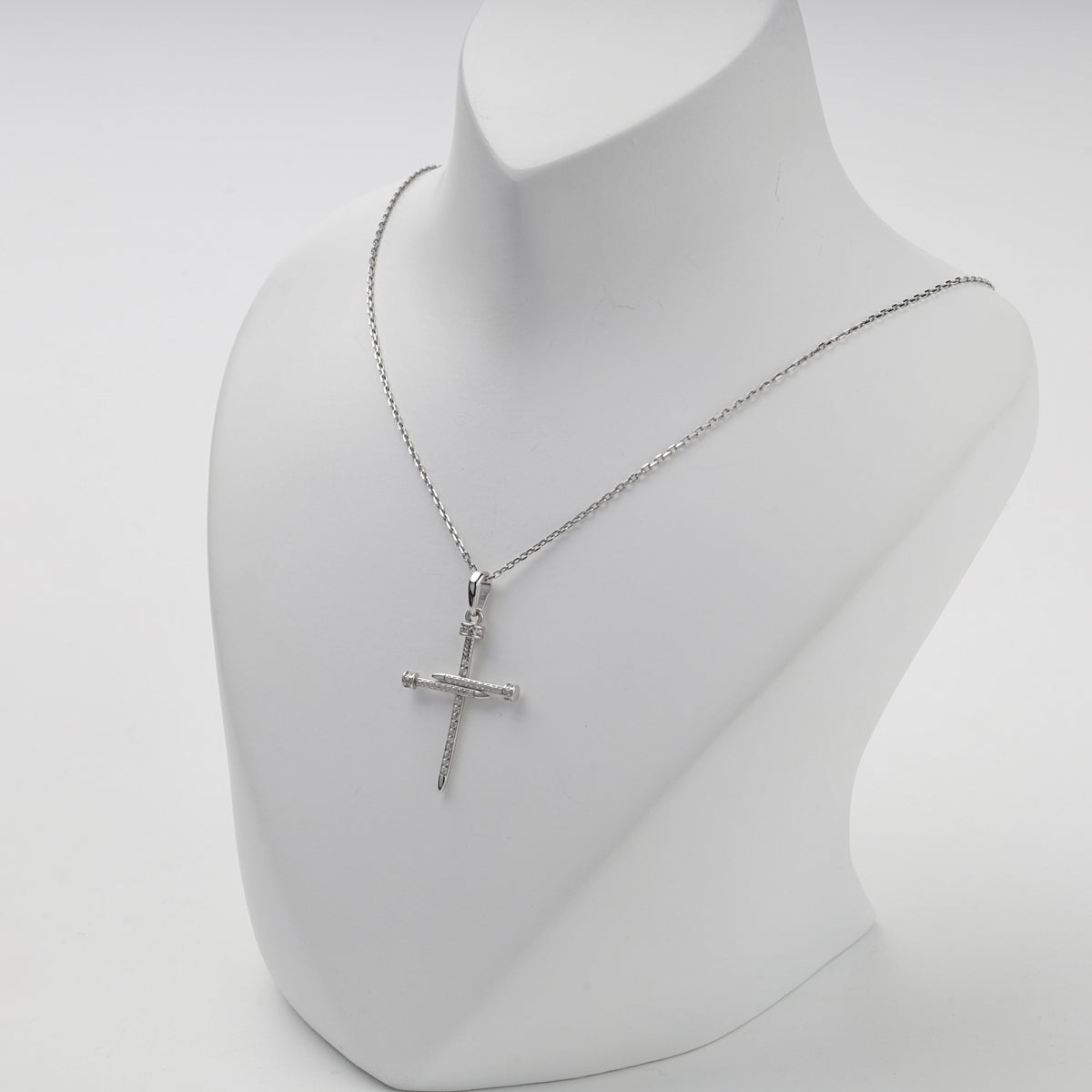 Silver 925 cubic zirconia nail cross pendant on display — Kabluchka