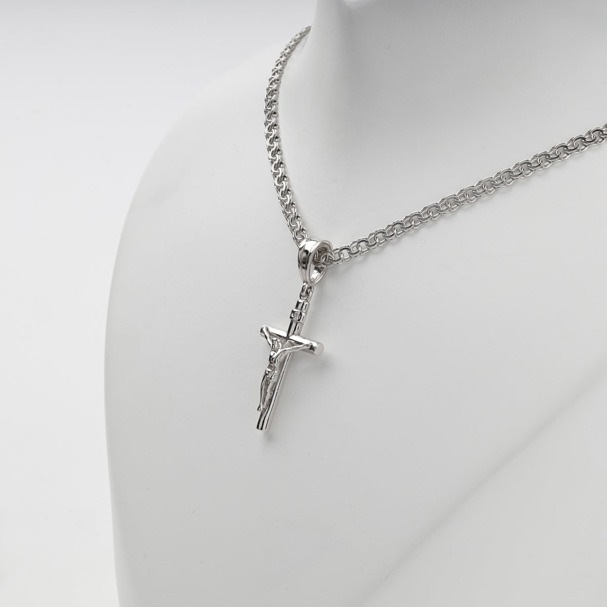 Silver 925 crucifix pendant showing smooth rounded cross arms