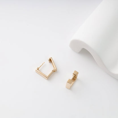 Detailed view of the hinged snap-lock mechanism and 585 hallmark on 14K rose gold square earrings.