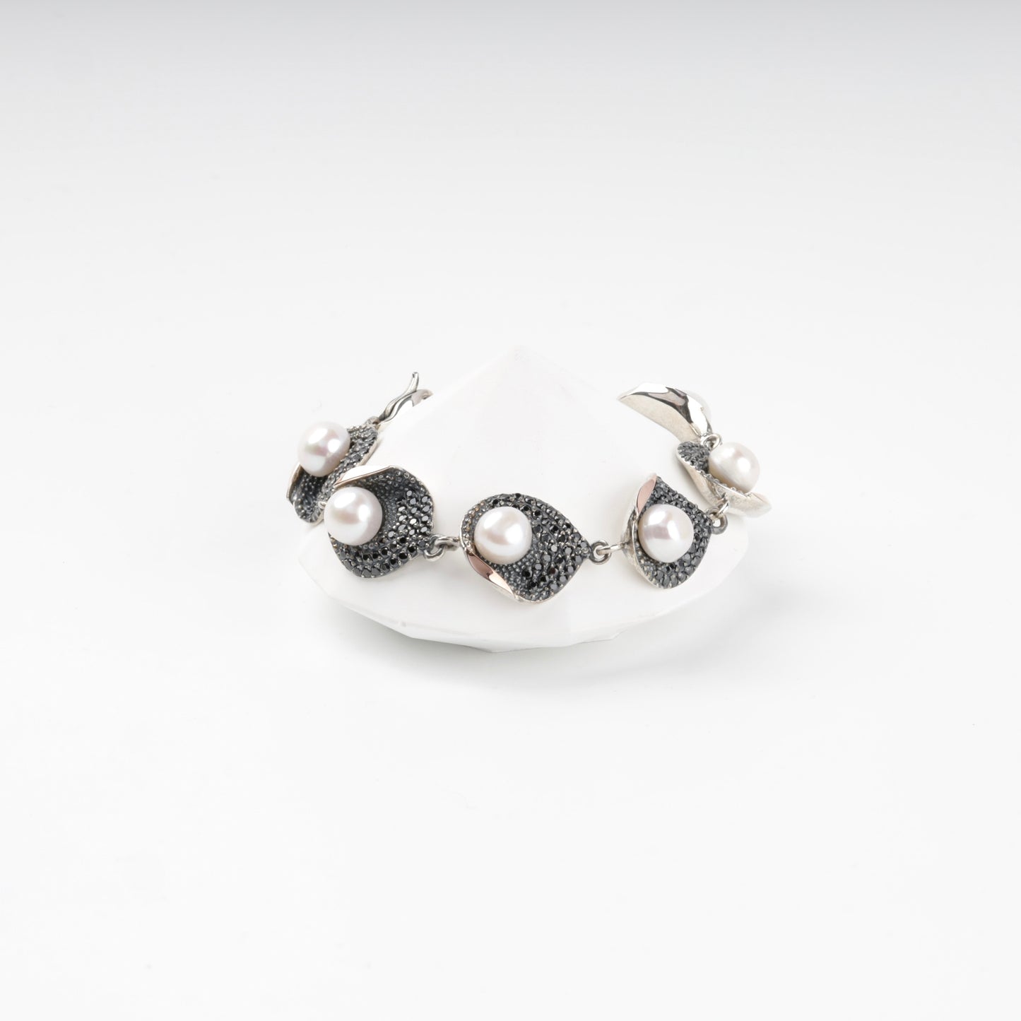 Silver and gold pearl link bracelet with dark cubic zirconia, front view