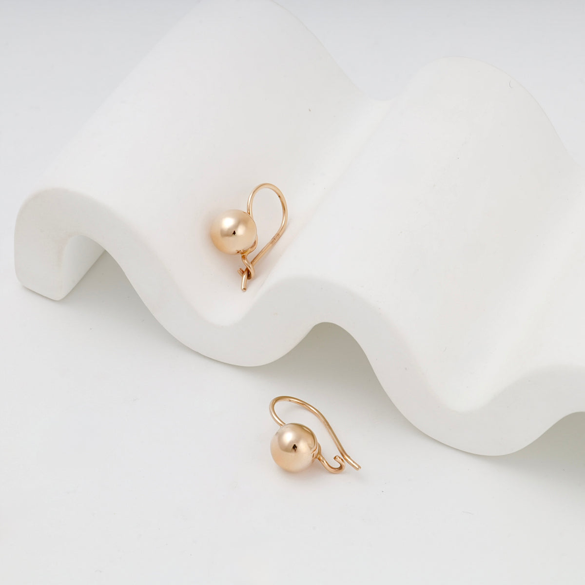 Polished ball drop kids earrings in Rose Gold 14K, angled view